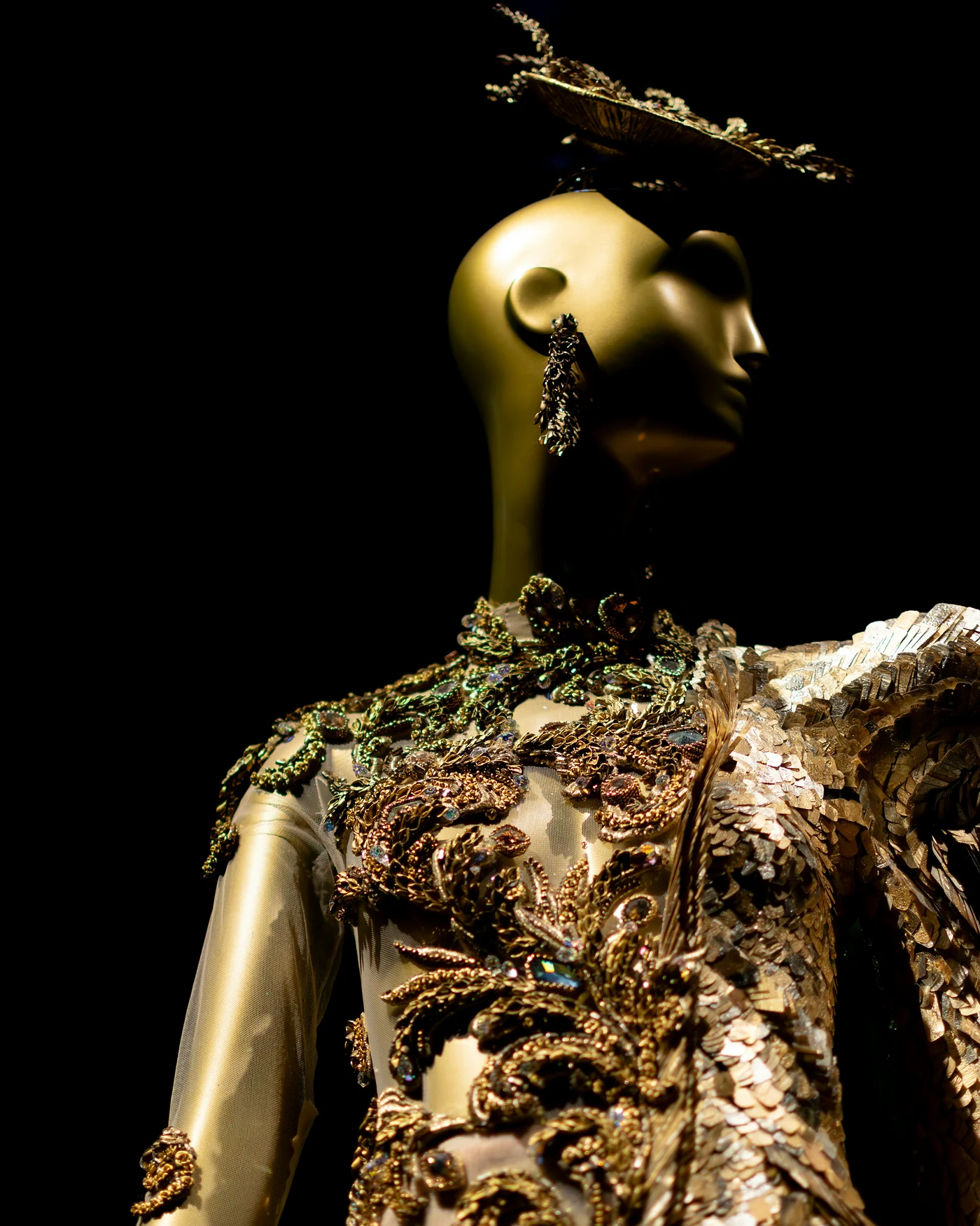 Gold sequinned couture gown on a dress form